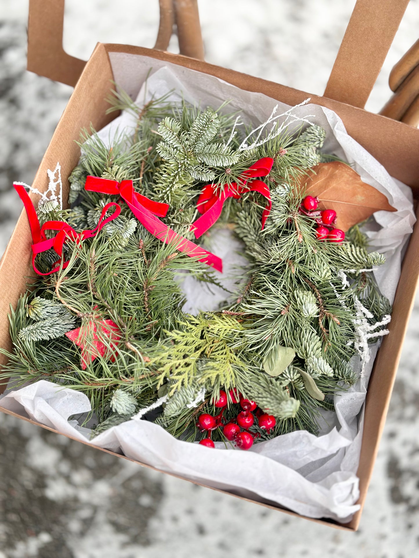 Christmas wreath with natural decor and gift box