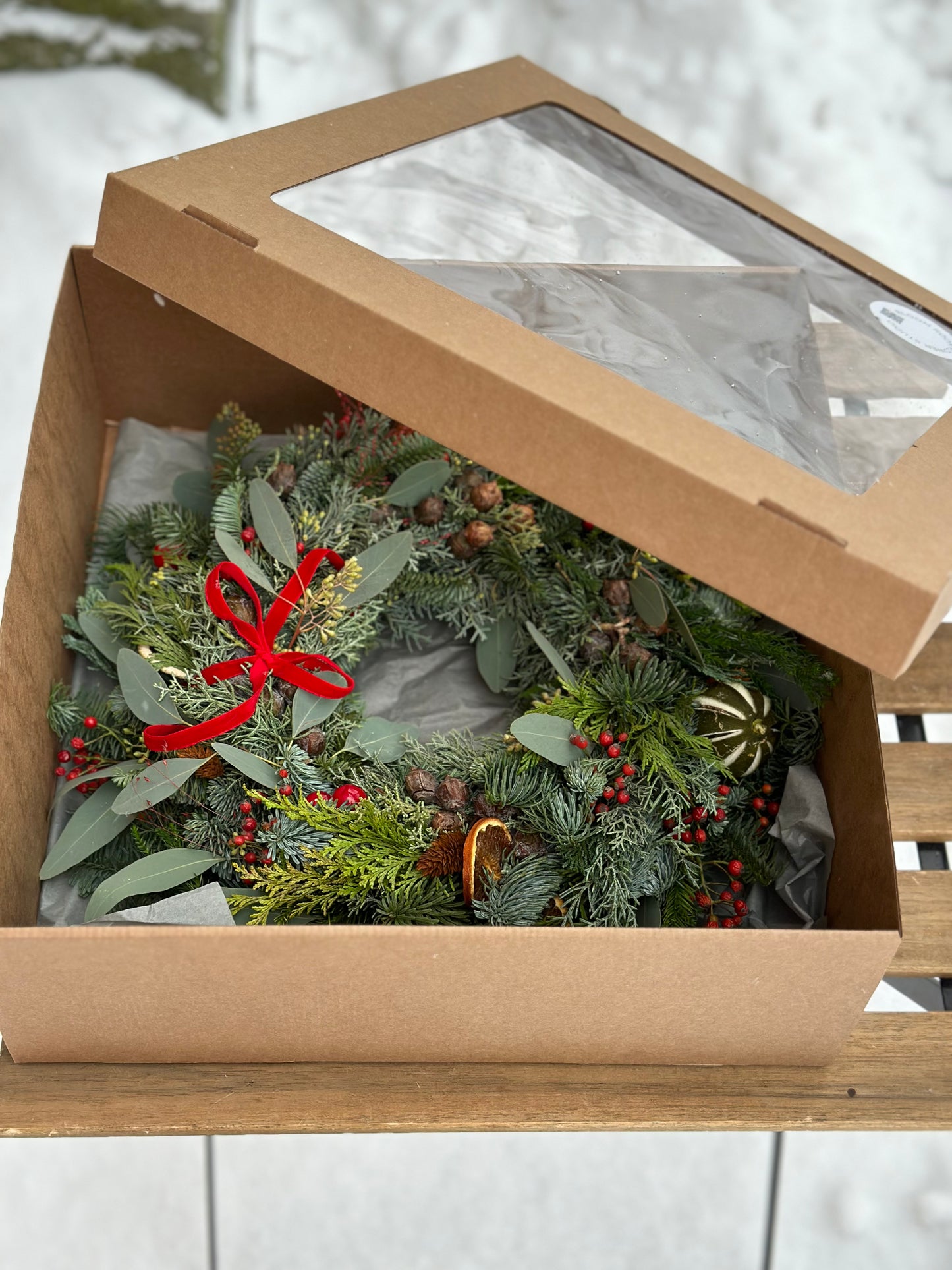 Christmas wreath with natural decor and gift box