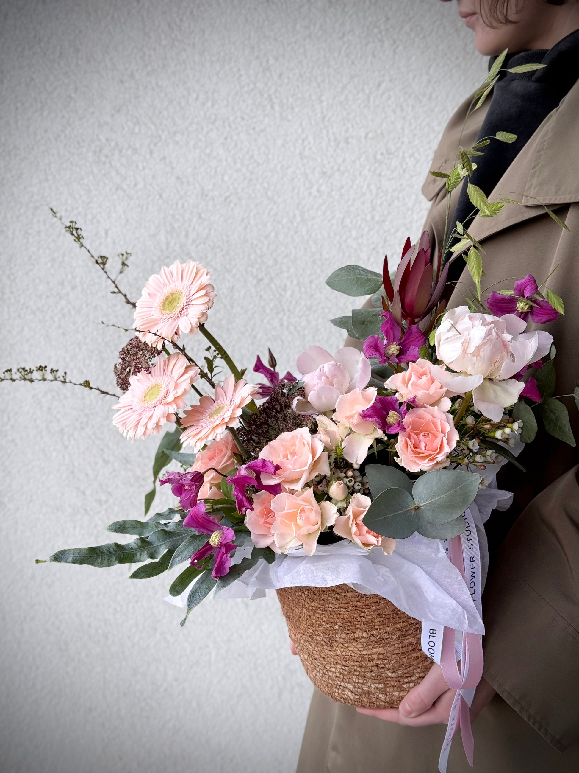 Signature flower arrangement in soft peach and blush tones, featuring spray roses, gerberas, eucalyptus, and seasonal blooms. A bubbly mix of elegance and cheer — like your favorite glass of prosecco in flower form. Comes in a natural basket with branded ribbon and care card.
