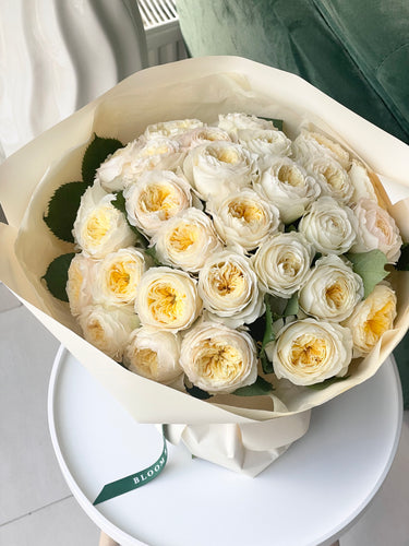 Mono bouquet with Cream yellow English garden roses wrapped  in light beige waterproof paper
